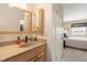 Bright bathroom featuring a modern vanity, updated fixtures, and convenient access to the bedroom at 10520 W 101St Pl, Westminster, CO 80021