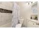 Updated bathroom with modern white marble-look wall tiles, tub with shower, and decorative vanity at 10520 W 101St Pl, Westminster, CO 80021