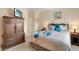 Well-appointed bedroom featuring a full bedroom set, neutral carpet, and warm, inviting lighting at 10520 W 101St Pl, Westminster, CO 80021