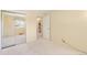 Neutral bedroom featuring light carpet, mirrored closets, and en-suite bathroom access at 10520 W 101St Pl, Westminster, CO 80021