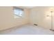 Bright, neutrally painted bedroom featuring light-colored carpet, a window, and warm lighting at 10520 W 101St Pl, Westminster, CO 80021