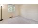 Neutral bedroom featuring light carpet, window, and ample lighting at 10520 W 101St Pl, Westminster, CO 80021