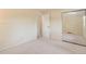 Neutral bedroom featuring bright, mirrored closet doors and convenient access to the hallway and en-suite bathroom at 10520 W 101St Pl, Westminster, CO 80021