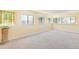 Bright bonus room featuring ample windows, neutral carpeting, and a unique stained glass window at 10520 W 101St Pl, Westminster, CO 80021