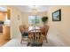 Warm dining room with wooden table, seating for six, and elegant chandelier at 10520 W 101St Pl, Westminster, CO 80021