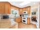 Well-equipped kitchen with granite countertops, stainless steel appliances, and oak cabinets at 10520 W 101St Pl, Westminster, CO 80021