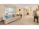 Spacious living room with large window, comfortable seating, and access to the staircase at 10520 W 101St Pl, Westminster, CO 80021