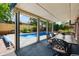 Covered patio with dining set, perfect for outdoor entertaining with a view of the pool at 10520 W 101St Pl, Westminster, CO 80021