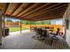 Comfortable back porch with outdoor seating, a fire pit, wood ceiling and view of the backyard at 11323 Albion St, Thornton, CO 80233