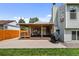 Expansive backyard featuring a covered patio, spacious lawn, and mature trees for outdoor enjoyment at 11323 Albion St, Thornton, CO 80233