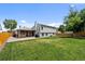 Spacious backyard with a covered patio, lush lawn, and privacy fence at 11323 Albion St, Thornton, CO 80233