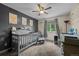 A cute Bedroom with a crib, side chair, dresser, window, and lovely decorative art at 11323 Albion St, Thornton, CO 80233