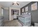 A cute Bedroom featuring a crib, closet with built-ins, and lovely decorative art at 11323 Albion St, Thornton, CO 80233