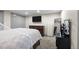 Bedroom featuring carpet floors, neutral paint, TV and multiple closets and a dressing table at 11323 Albion St, Thornton, CO 80233