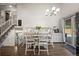 Bright dining area with modern chandelier, large table, and easy access to the nearby kitchen area at 11323 Albion St, Thornton, CO 80233