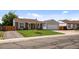 Inviting single-Gathering home featuring a lush green lawn, mature tree, and an attached garage at 11323 Albion St, Thornton, CO 80233