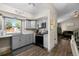 Modern kitchen with updated appliances, grey cabinets, granite counters, and easy access to living room at 11323 Albion St, Thornton, CO 80233