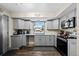 Grey kitchen with granite counters, hardwood floors, plenty of storage and modern appliances at 11323 Albion St, Thornton, CO 80233
