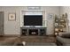 Cozy living room featuring a modern entertainment center with a built-in fireplace and a large TV at 11323 Albion St, Thornton, CO 80233