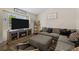 Comfortable living room with a modern entertainment center featuring a fireplace and a large television at 11323 Albion St, Thornton, CO 80233