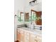 A double vanity bathroom with modern fixtures, a large mirror, and decorative features at 10260 Longview Dr, Lone Tree, CO 80124