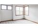 Light-filled bedroom featuring new carpet, three windows with wood trim, and neutral paint at 10260 Longview Dr, Lone Tree, CO 80124
