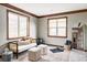 Bonus room with natural light, modern furniture, and a large mirror making this space a great workout area at 10260 Longview Dr, Lone Tree, CO 80124