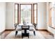 Bright dining room with hardwood floors, a modern chandelier, and large windows at 10260 Longview Dr, Lone Tree, CO 80124