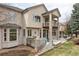 Elegant two-story home with a private balcony and outdoor seating on the deck at 10260 Longview Dr, Lone Tree, CO 80124