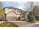 Beautiful two-story home with stone accents, a three-car garage, and well-maintained landscaping at 10260 Longview Dr, Lone Tree, CO 80124