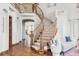 Grand foyer featuring a staircase, hardwood floors, and elegant decor at 10260 Longview Dr, Lone Tree, CO 80124