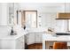 Bright kitchen featuring white cabinets, stone countertops, a window, and stainless steel appliances at 10260 Longview Dr, Lone Tree, CO 80124