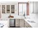 Kitchen featuring white cabinets, stone countertops, a window, stainless steel appliances and wood floors at 10260 Longview Dr, Lone Tree, CO 80124