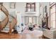 Bright living room with vaulted ceilings, fireplace, and staircase with wood accents at 10260 Longview Dr, Lone Tree, CO 80124