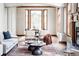 Cozy living room showing chairs and a view into the adjacent dining area at 10260 Longview Dr, Lone Tree, CO 80124