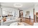 Spacious living room with hardwood floors and an open layout leading to the kitchen at 10260 Longview Dr, Lone Tree, CO 80124
