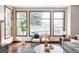 Cozy living room with bright windows overlooking the backyard and plush seating at 10260 Longview Dr, Lone Tree, CO 80124