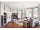Bright and inviting living room with a fireplace, large windows, hardwood floors and comfortable seating at 10260 Longview Dr, Lone Tree, CO 80124