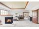A spacious primary bedroom with a fireplace, tray ceilings, wood accents, and an open doorway at 10260 Longview Dr, Lone Tree, CO 80124