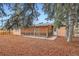 Backyard featuring a covered patio with wood lattice and mulch ground cover at 3107 S Wolff St, Denver, CO 80236