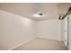 This bedroom offers neutral carpeting, light walls, and an electrical outlet at 3107 S Wolff St, Denver, CO 80236