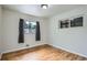 This room has hardwood floors, natural light, and neutral gray curtains at 3107 S Wolff St, Denver, CO 80236