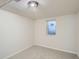 This bedroom offers neutral carpeting, light walls, and a window for natural lighting at 3107 S Wolff St, Denver, CO 80236