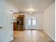 Bright dining area features tiled flooring, stainless steel fridge, and glass patio doors at 3107 S Wolff St, Denver, CO 80236