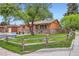 Street view of an inviting home with a manicured lawn and mature trees shading the facade at 3107 S Wolff St, Denver, CO 80236