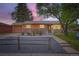 Charming single-story home showcasing a stone facade, orange trim, and well-maintained landscaping at 3107 S Wolff St, Denver, CO 80236