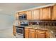 Well-equipped kitchen featuring stainless steel appliances, tile backsplash, and granite countertops at 3107 S Wolff St, Denver, CO 80236