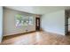 Bright living room featuring beautiful hardwood floors, fresh paint, and a view to the front yard at 3107 S Wolff St, Denver, CO 80236
