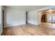 Spacious living room featuring hardwood floors, neutral paint, and seamless flow into the kitchen at 3107 S Wolff St, Denver, CO 80236