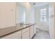 Bright bathroom with grey countertops, double sinks, tile floor, and modern fixtures at 712 N Bently St, Watkins, CO 80137